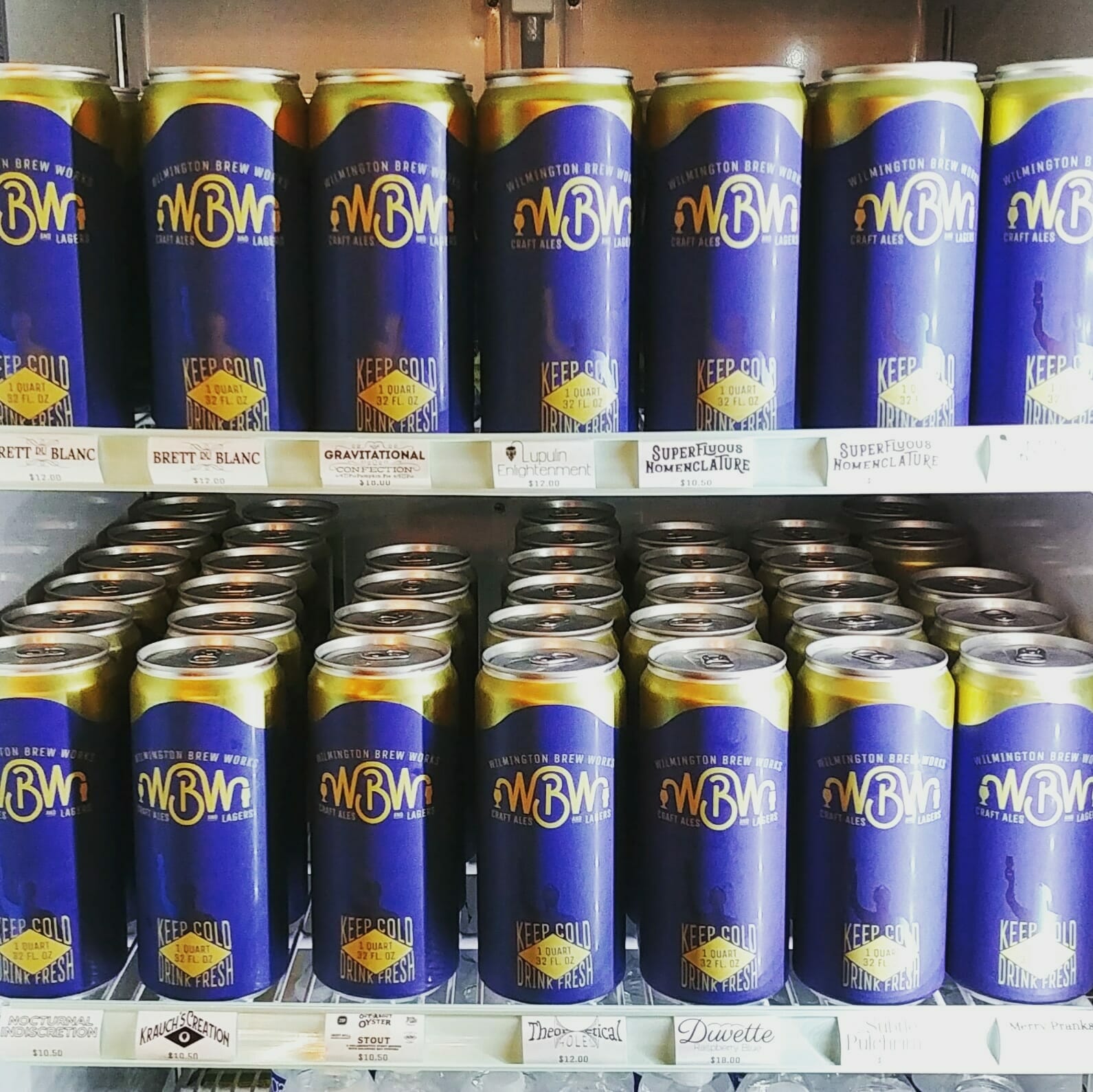 Picture of a fridge full of 32 ounce crowlers